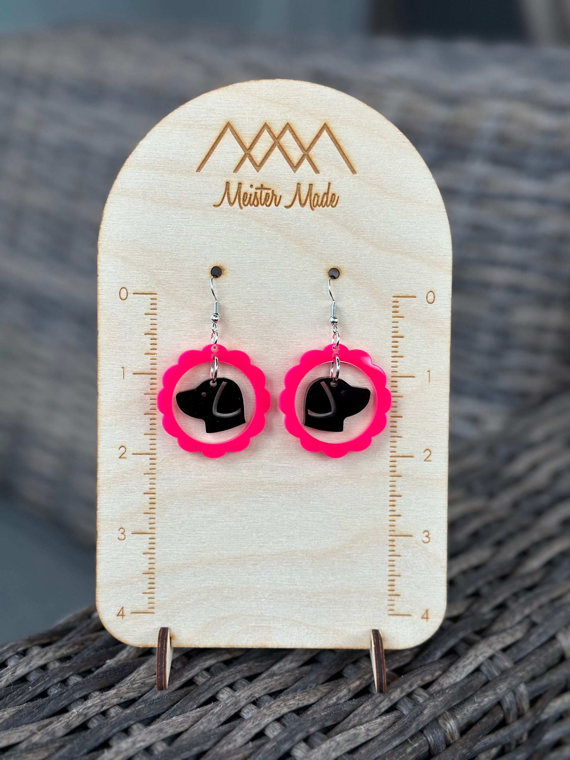 hot pink frame with a black dog earrings
