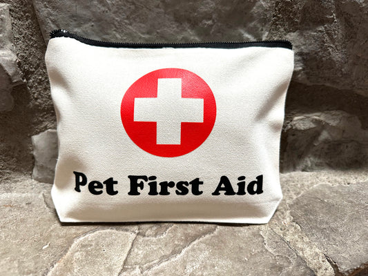 Pet first aid kit with a red cross symbol on a stone surface