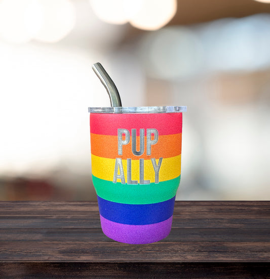 Rainbow-colored tumbler with 'PUP ALLY' text on a wooden surface