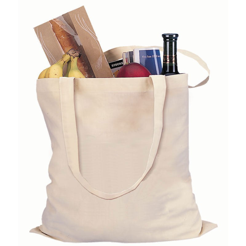 canvas tote bag filled with groceries on a white background