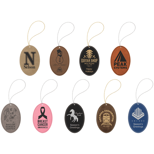 A collection of oval vegan leather ornaments with various engravings, attached to a string, displayed against a white background.