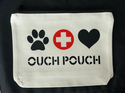 canvas pouch with black paw print, red cross, black heart, and 'OUCH POUCH' text on a black background.